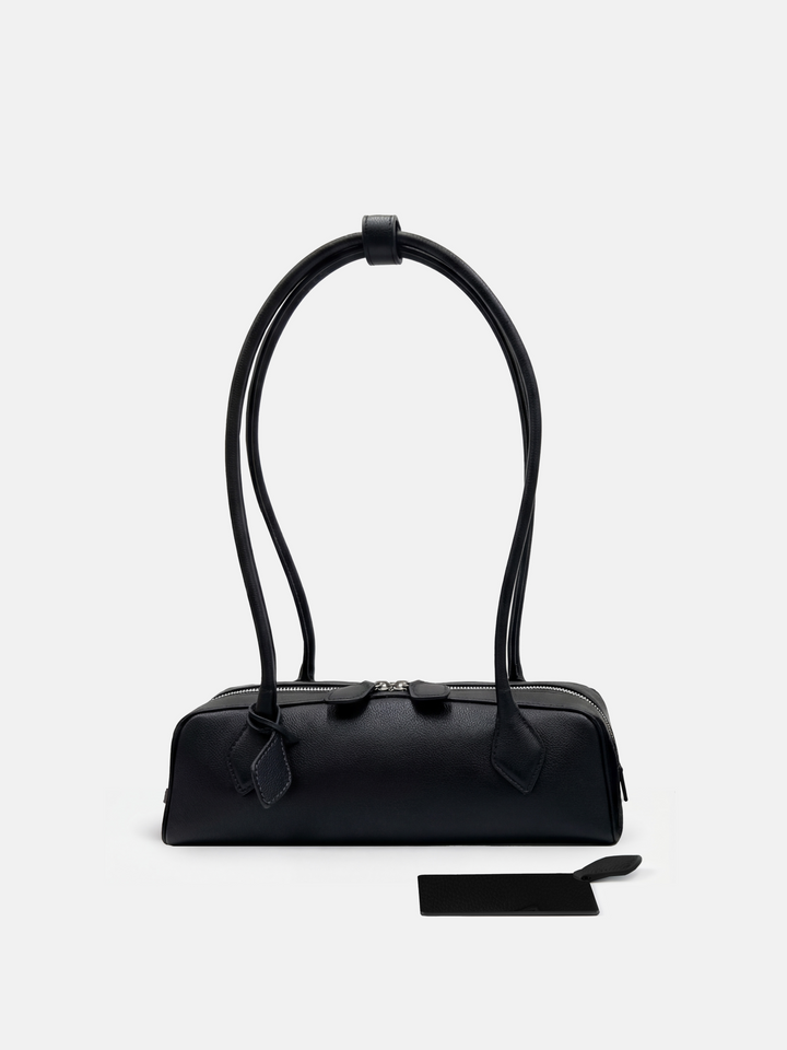 SELVANE Sausage Zipper Shoulder Bag in custom leather, longline, low-profile, softly rounded, with a streamlined zipper top.