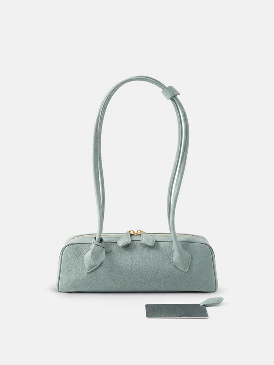 SELVANE Sausage Zipper Shoulder Bag in custom leather, longline, low-profile, softly rounded, with a streamlined zipper top.