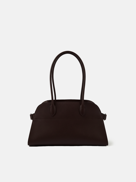 Structured deep navy saddle leather top handle bag with clean curves and elegant trapezoid shape.