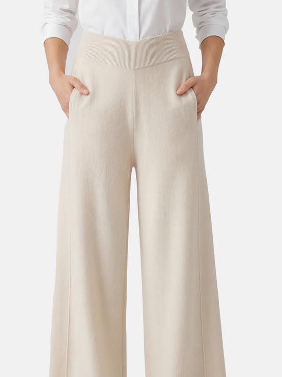 Ivory cashmere wide-leg pants by SELVANE, featuring a soft V-shaped rib waistband and elegant vertical drape.