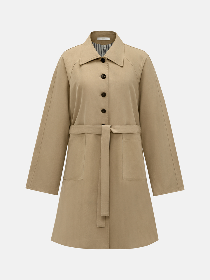 SELVANE light khaki straight-line trench coat with distinctive striped turn-up cuffs, showcasing controlled volume and fluid drape.