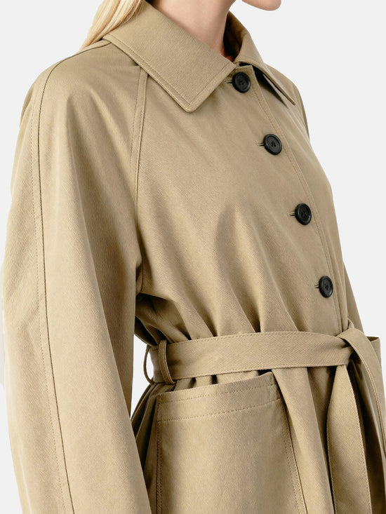 SELVANE light khaki straight-line trench coat with distinctive striped turn-up cuffs, showcasing controlled volume and fluid drape.