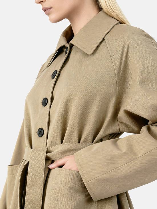 SELVANE light khaki straight-line trench coat with distinctive striped turn-up cuffs, showcasing controlled volume and fluid drape.