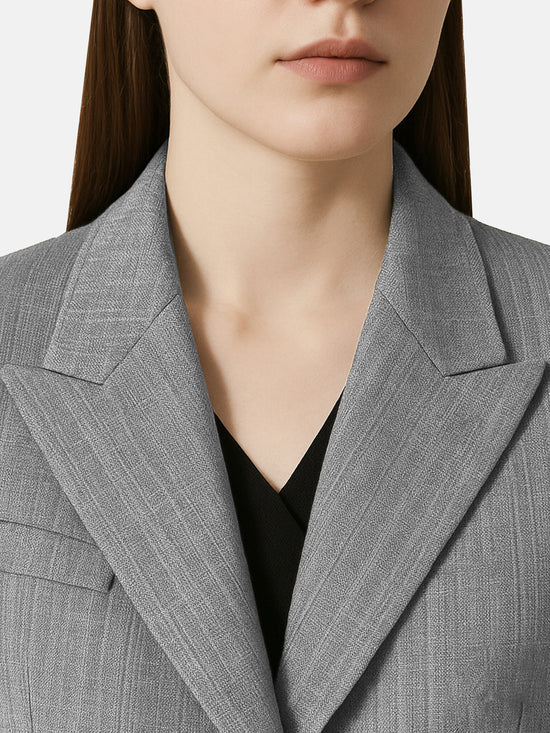 SELVANE Diagonal-Closure Asymmetric Collar Blazer in quiet grey. Sharp shoulders, diagonal closure, and asymmetric collar define its long, clean silhouette.