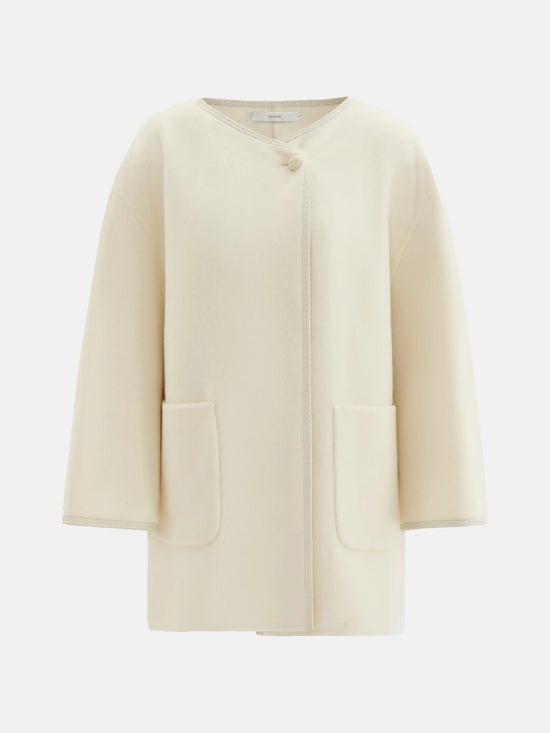 SELVANE asymmetric single-button wool coat in calm ivory, featuring a clear line and composed silhouette.