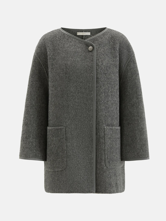 SELVANE asymmetric single-button wool coat in calm ivory, featuring a clear line and composed silhouette.