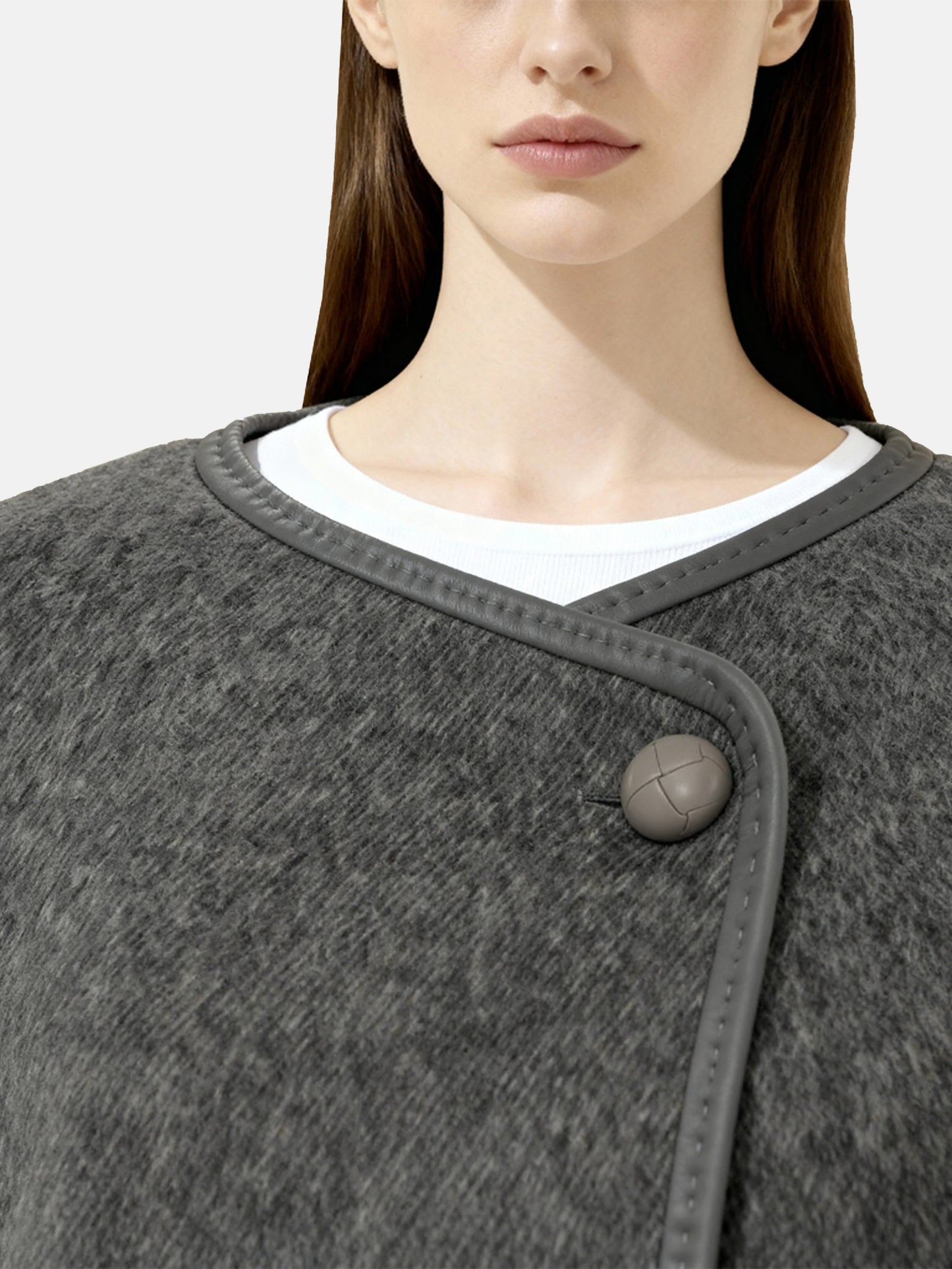 SELVANE asymmetric single-button wool coat in calm ivory, featuring a clear line and composed silhouette.
