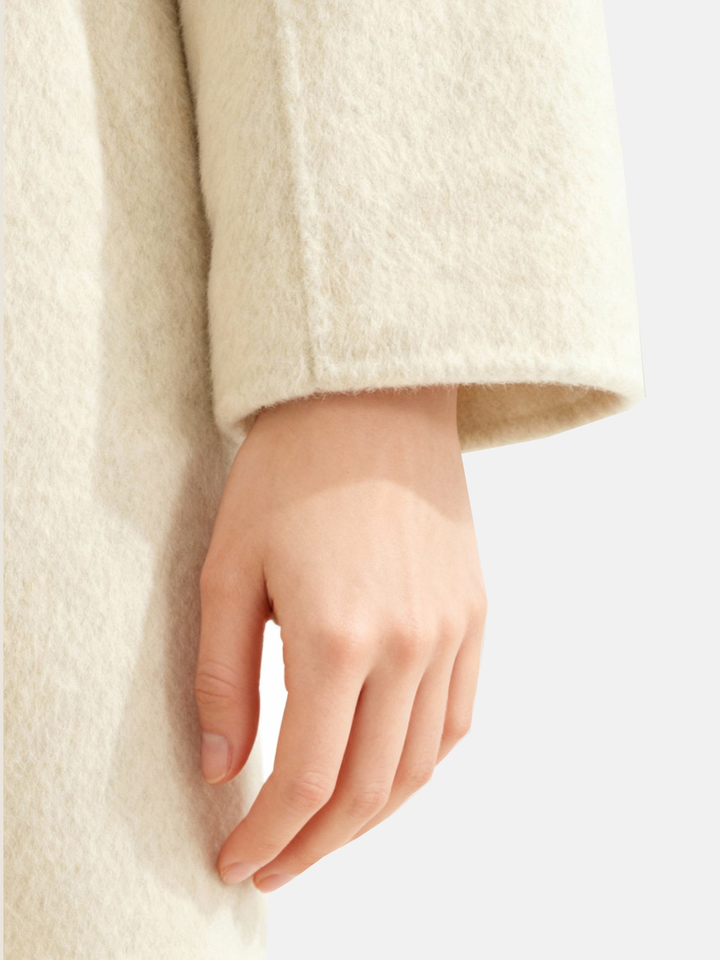 SELVANE Contour Wool Wrap Coat in a light tone with contrast-trim edges and wide shawl collar, draped elegantly.