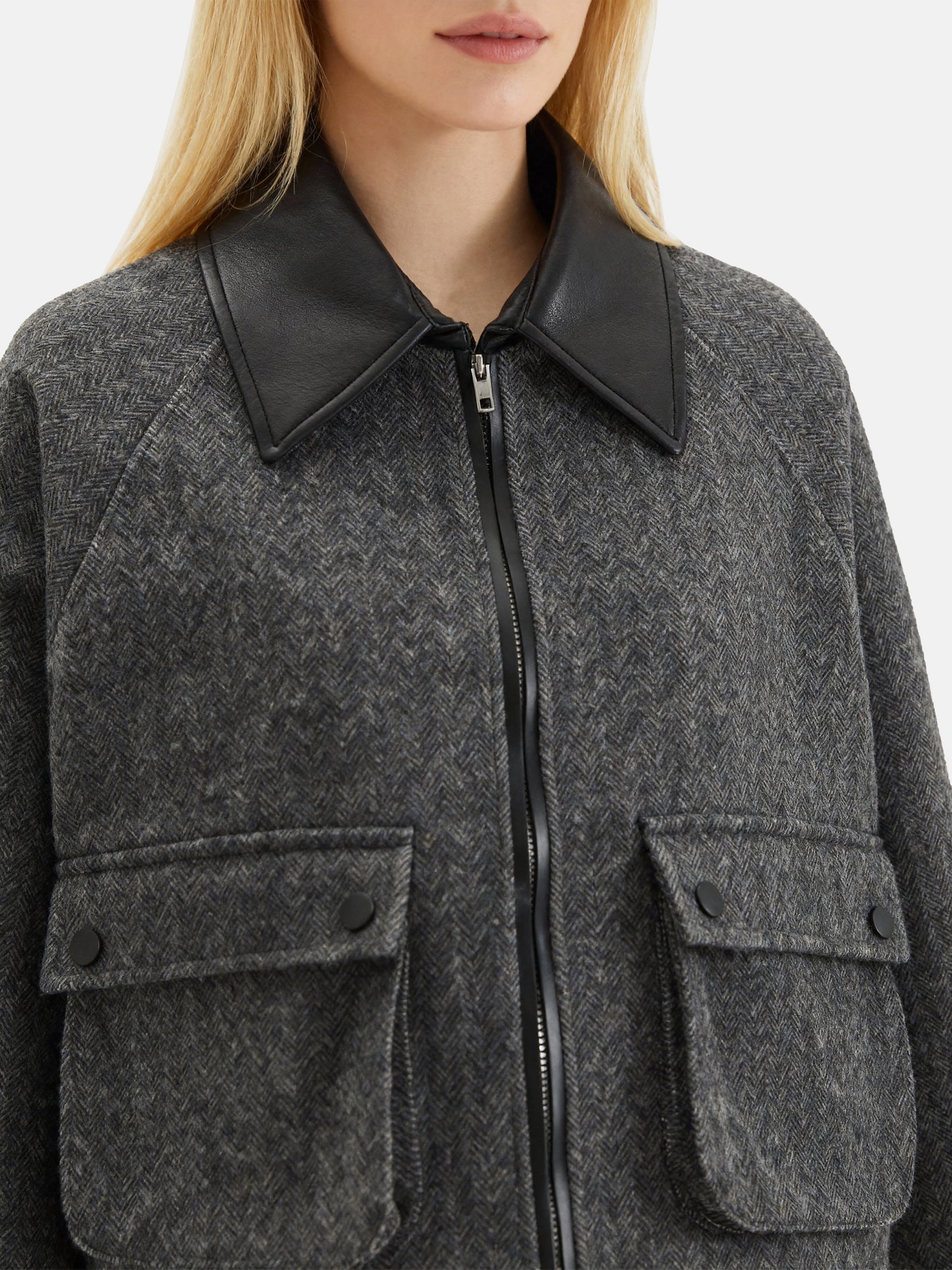 Charcoal wool-blend two-piece set featuring a cropped, boxy jacket with a sharp faux-leather contrast collar and a clean straight skirt.