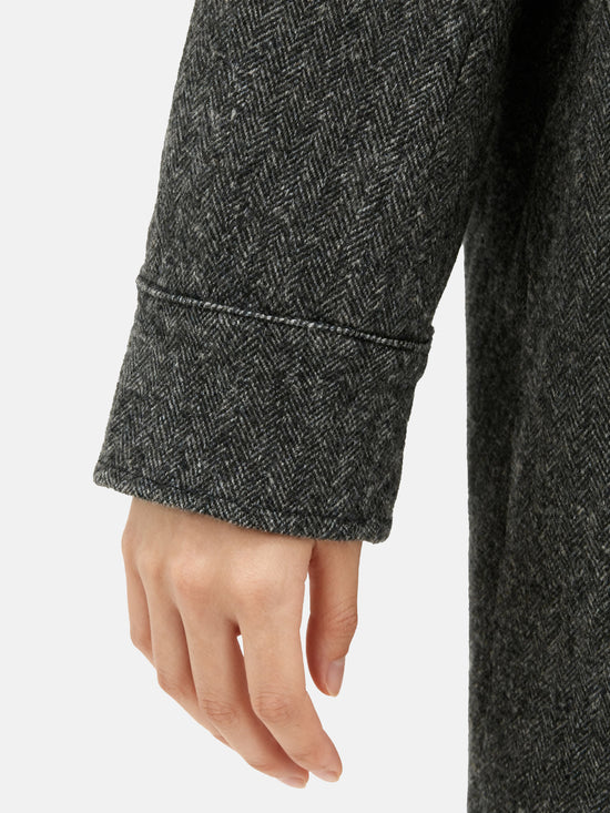 Charcoal wool-blend two-piece set featuring a cropped, boxy jacket with a sharp faux-leather contrast collar and a clean straight skirt.