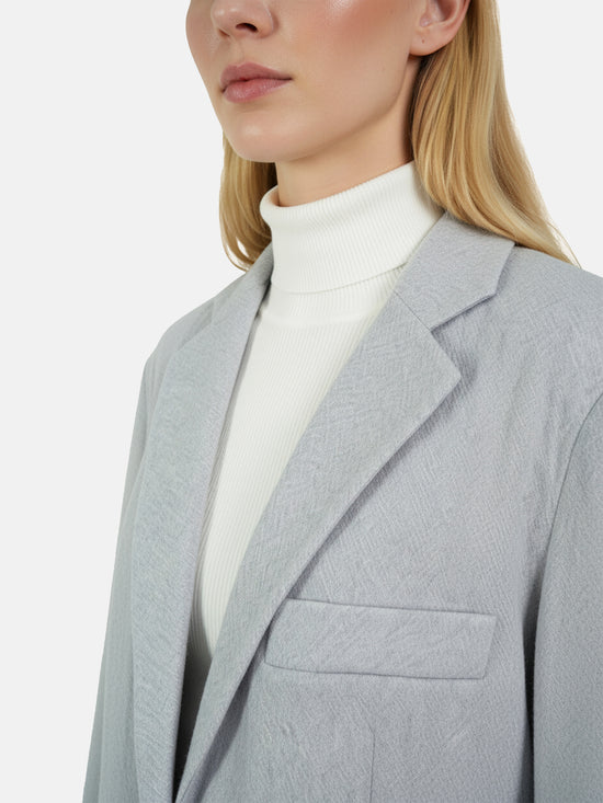 Structured worsted wool jacket with mulberry silk lining, tailored fit, shown on a model in a thoughtful pose.