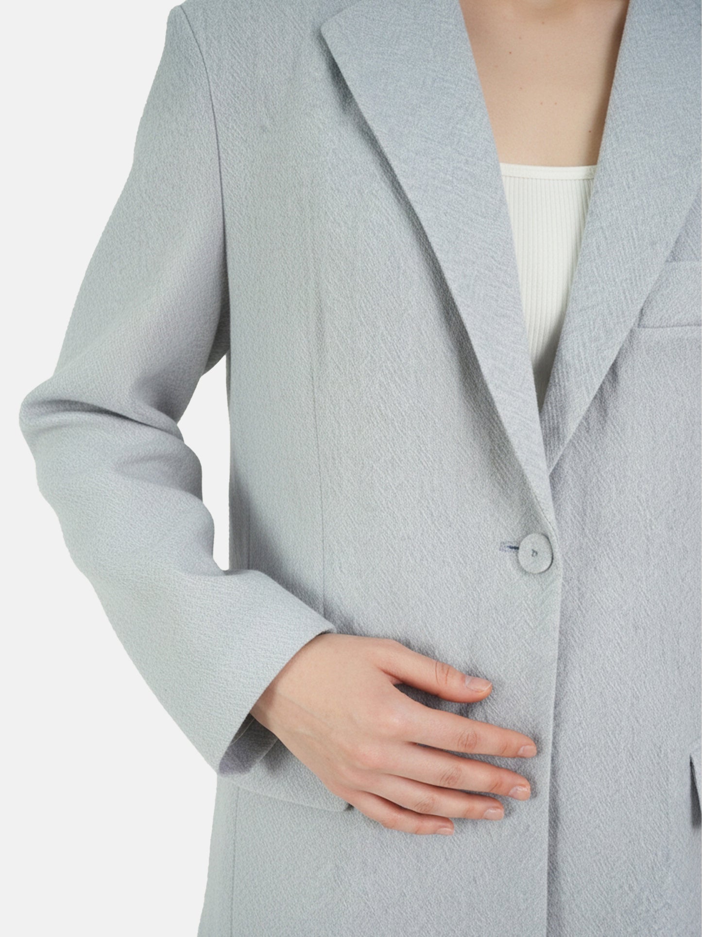 Structured worsted wool jacket with mulberry silk lining, tailored fit, shown on a model in a thoughtful pose.