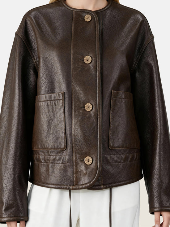 SELVANE brown lambskin crew-neck jacket with softened volume and drawstring hem, showcasing clean lines and supple texture.