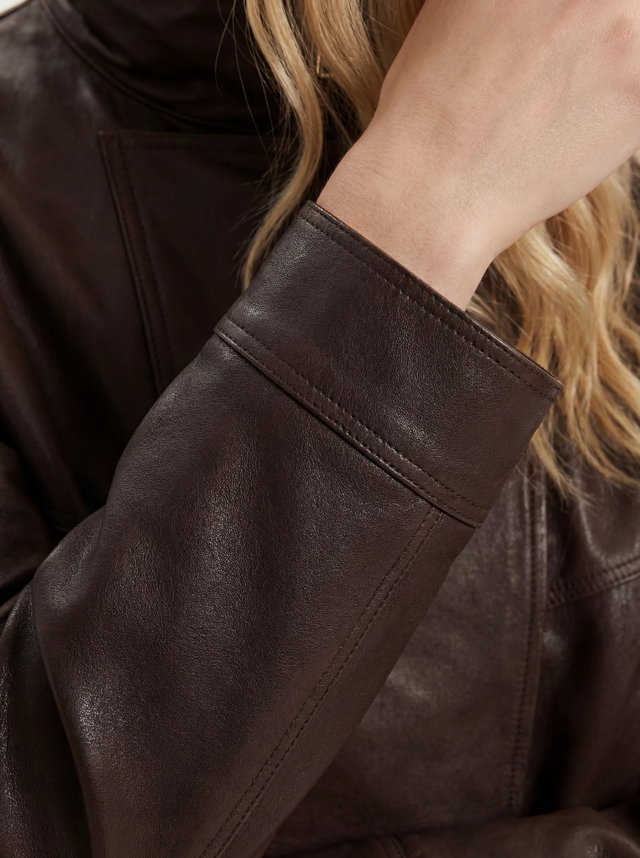 SELVANE Asymmetric Zip-Collar Lambskin Jacket in coffee-toned leather, showcasing its structural lines and urban elegance.