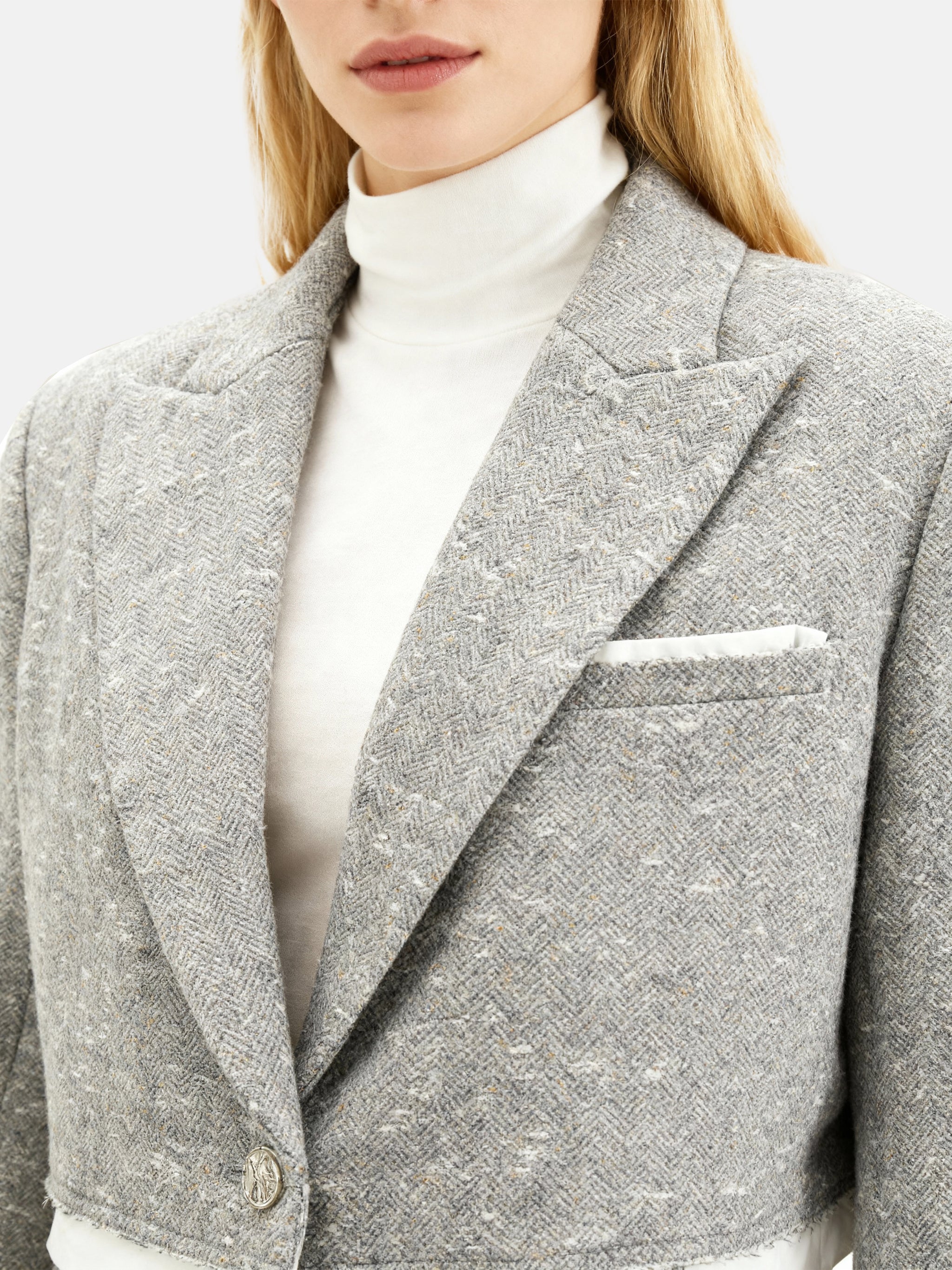 Cropped blazer and wrap midi skirt set in grey, featuring disciplined shoulders and fluid lines, inspired by volcanic terrain.