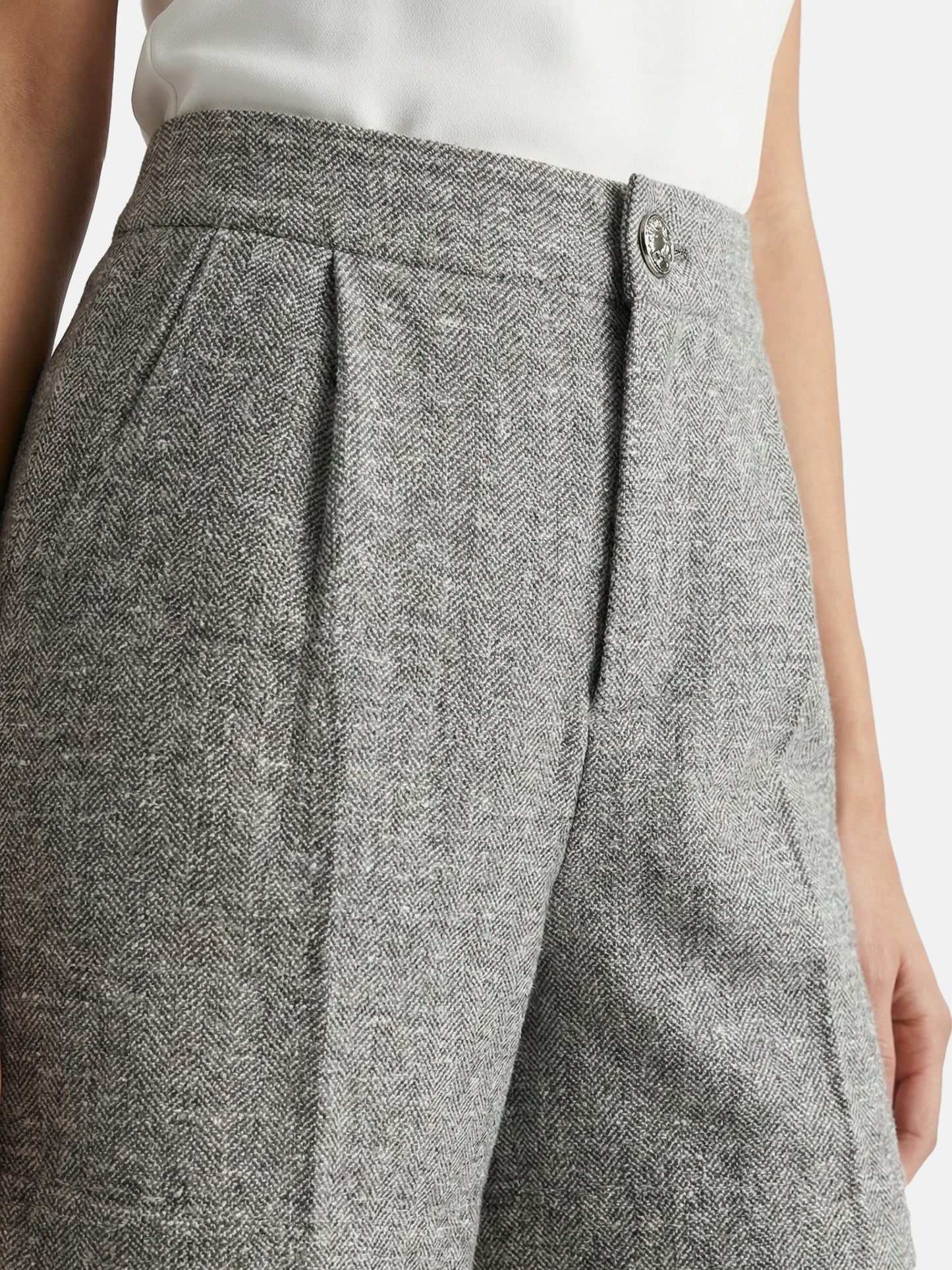 High-waisted grey mélange tailored shorts with front pleats, slightly flared leg, and subtle contrast pocket trims.