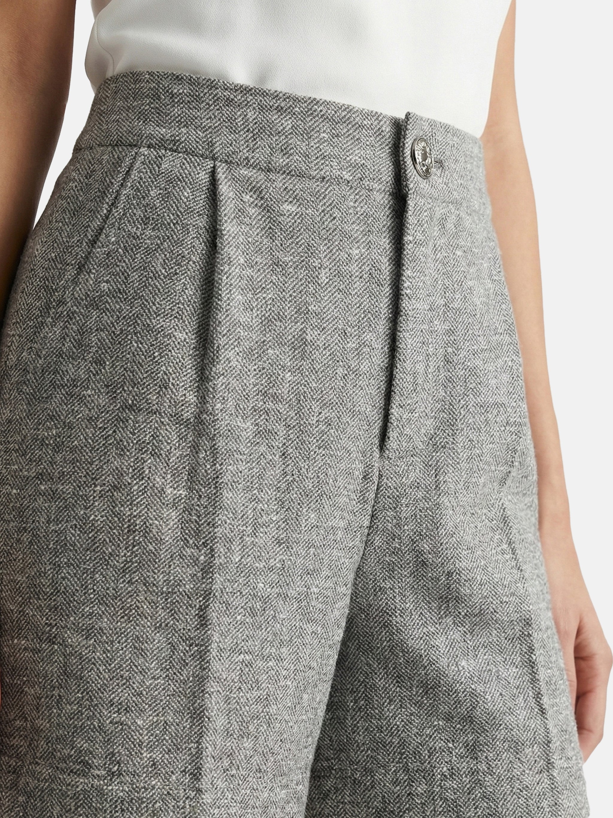 High-waisted grey mélange tailored shorts with front pleats, slightly flared leg, and subtle contrast pocket trims.