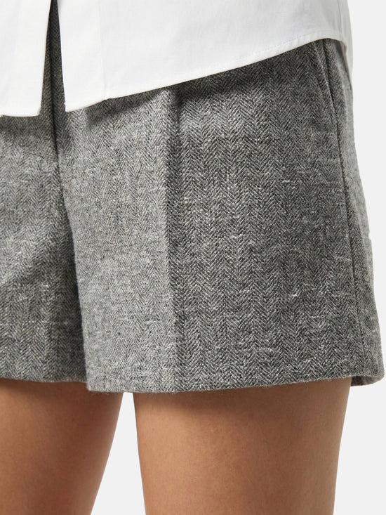 High-waisted grey mélange tailored shorts with front pleats, slightly flared leg, and subtle contrast pocket trims.