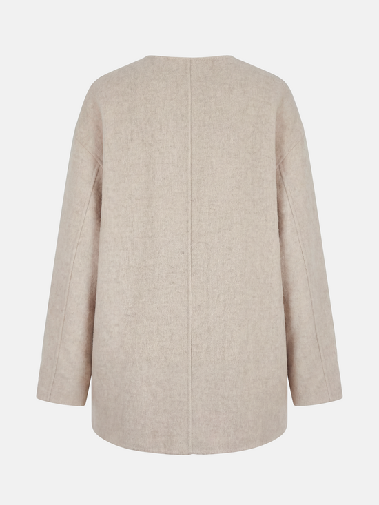 Beige wool and camel hair buttoned coat by SELVANE, featuring a rounded neck and minimal buttons, draped elegantly.