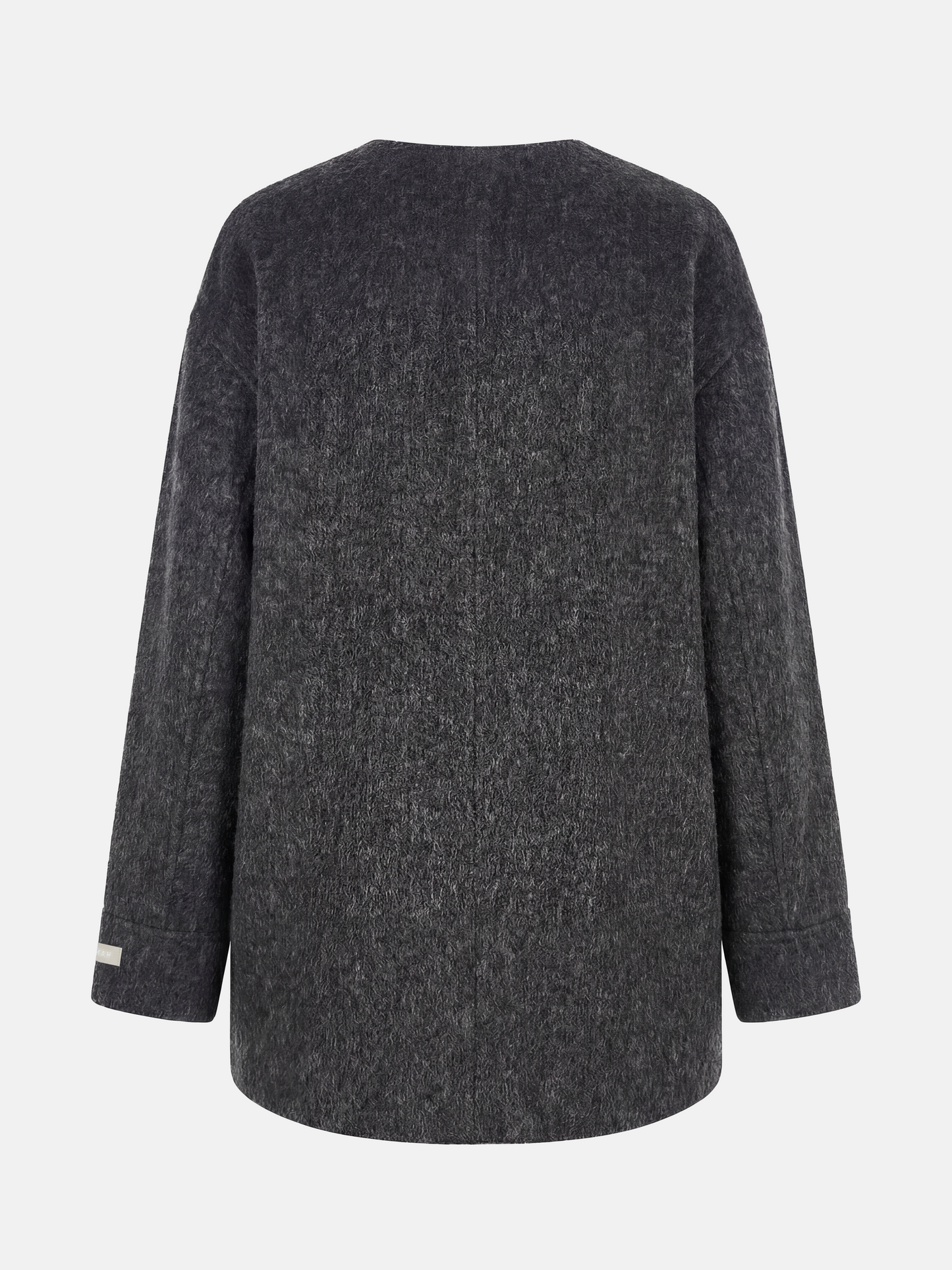 Beige wool and camel hair buttoned coat by SELVANE, featuring a rounded neck and minimal buttons, draped elegantly.