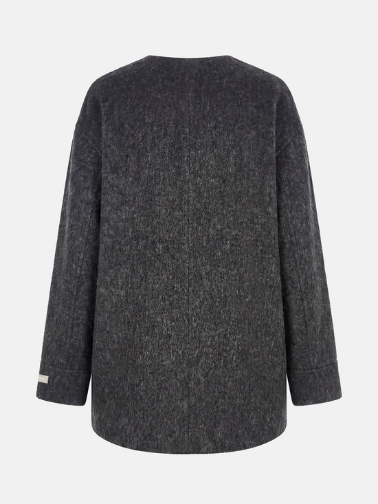 Beige wool and camel hair buttoned coat by SELVANE, featuring a rounded neck and minimal buttons, draped elegantly.