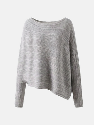 Cashmere draped knit top in grey with wide boat neckline and asymmetric hem, showcasing fluid motion and refined rib sleeves.