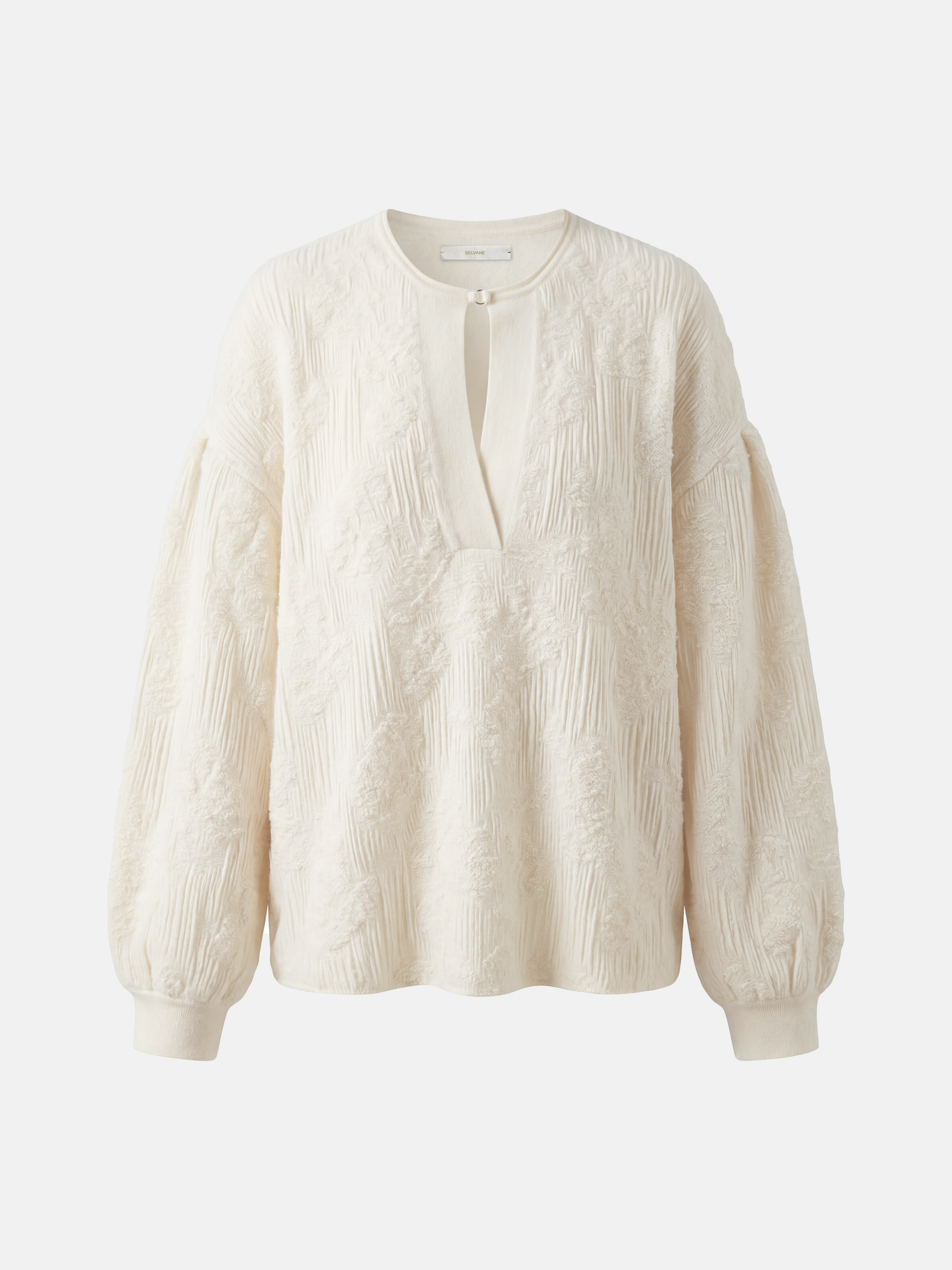 Relaxed ivory cashmere knit top featuring a clean round neck, deep slit, soft volume sleeves with neat cuffs, and a distinctive raised texture.