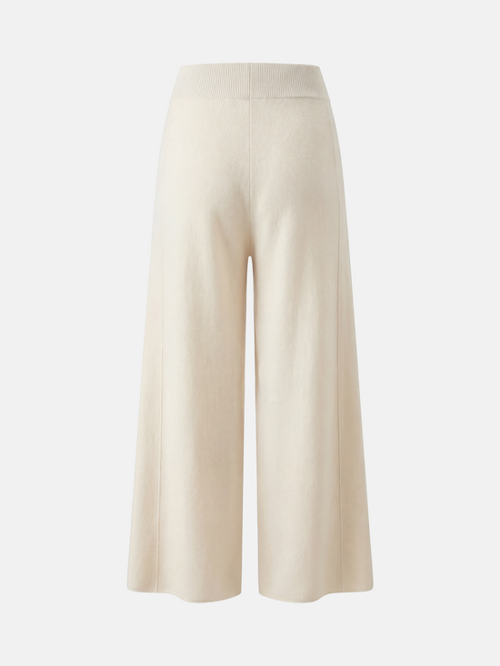 Ivory cashmere wide-leg pants by SELVANE, featuring a soft V-shaped rib waistband and elegant vertical drape.
