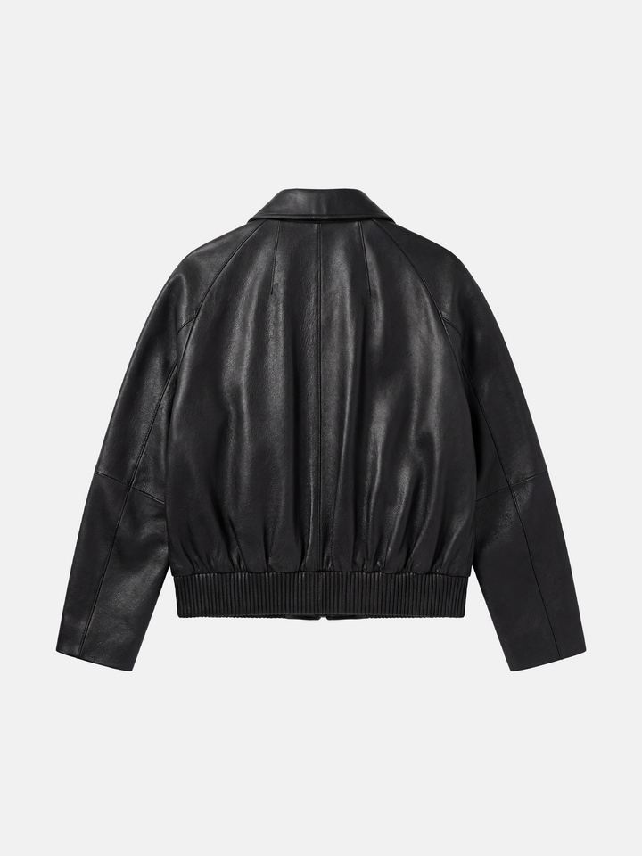 SELVANE deep black lambskin button bomber, cropped silhouette with ribbed hem and oversized patch pockets.