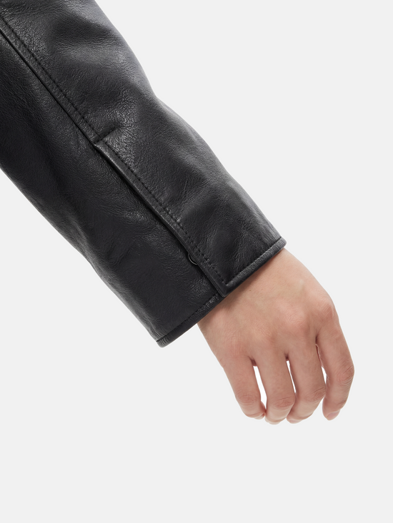 SELVANE deep black lambskin button bomber, cropped silhouette with ribbed hem and oversized patch pockets.