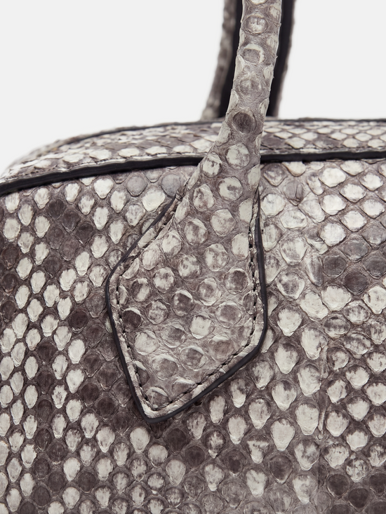 SELVANE Snake Scale Zip Baguette Bag, a slim, structured silhouette with unique scale texture and secure zip-top, worn under arm.