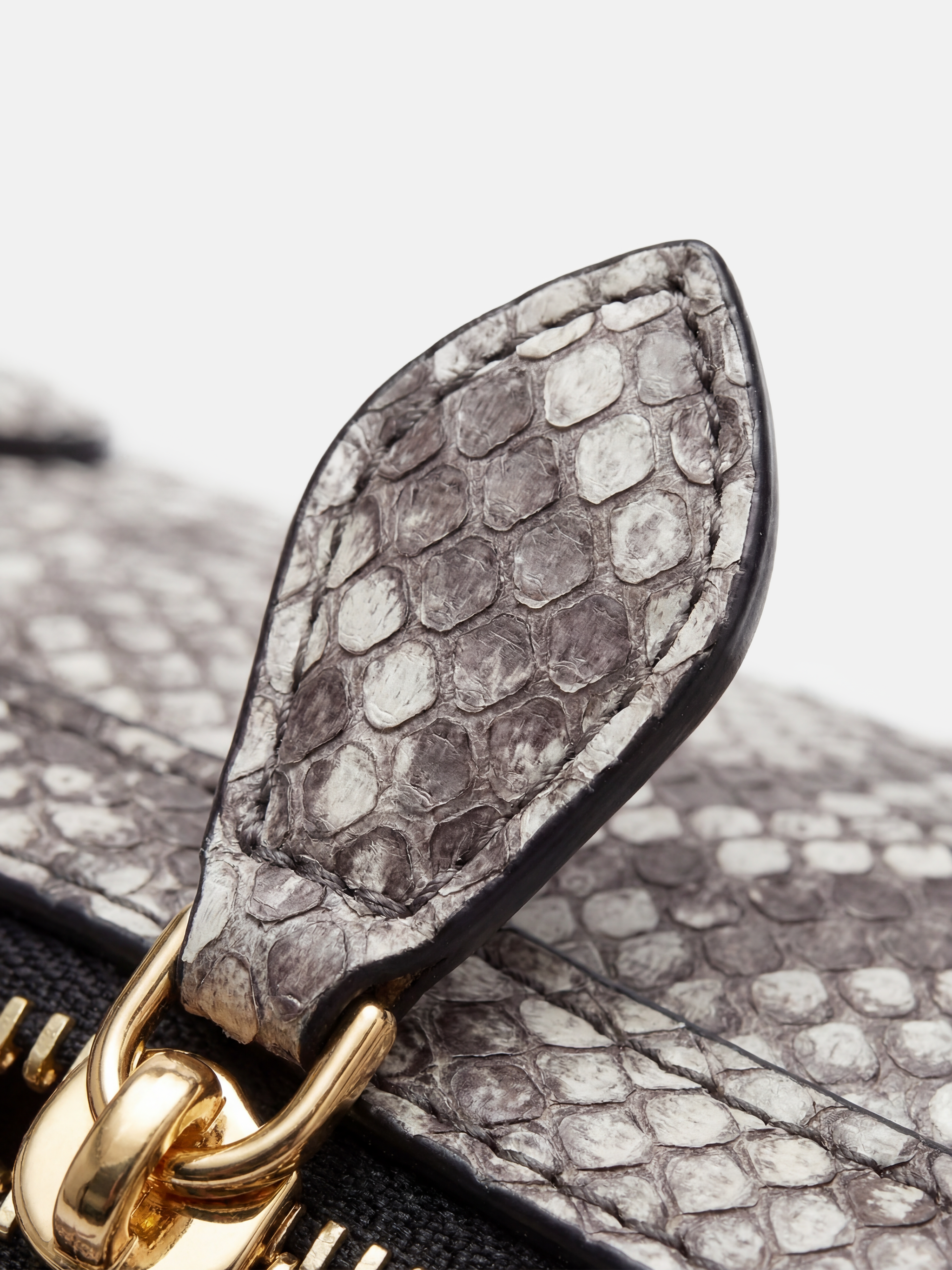 SELVANE Snake Scale Zip Baguette Bag, a slim, structured silhouette with unique scale texture and secure zip-top, worn under arm.