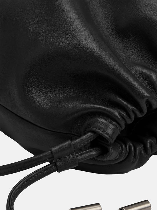 SELVANE soft drawstring pouch bag in a gentle, rounded silhouette with gathered top and secure strap.