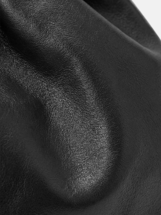 SELVANE soft drawstring pouch bag in a gentle, rounded silhouette with gathered top and secure strap.