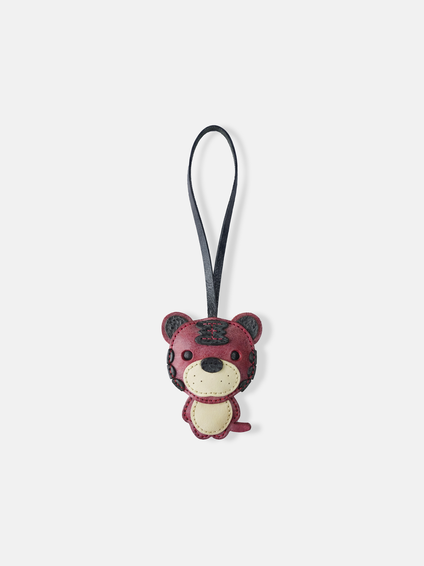 Hand-stitched leather Selvane Tiger Bag Charm, showcasing a playful yet fierce, bold, and compact design.