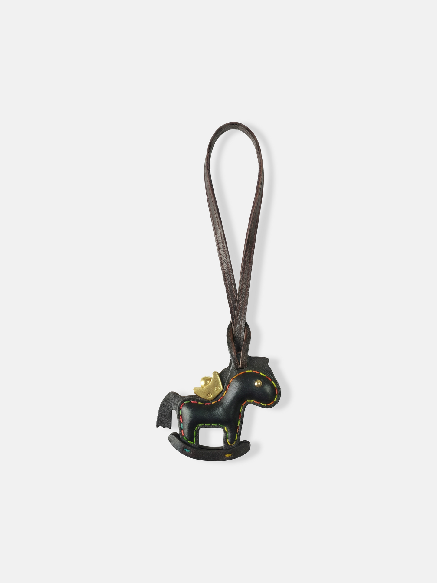 Deep green leather rocking horse bag charm with a gold-tone crown, compact and graphic, attached to a bag.
