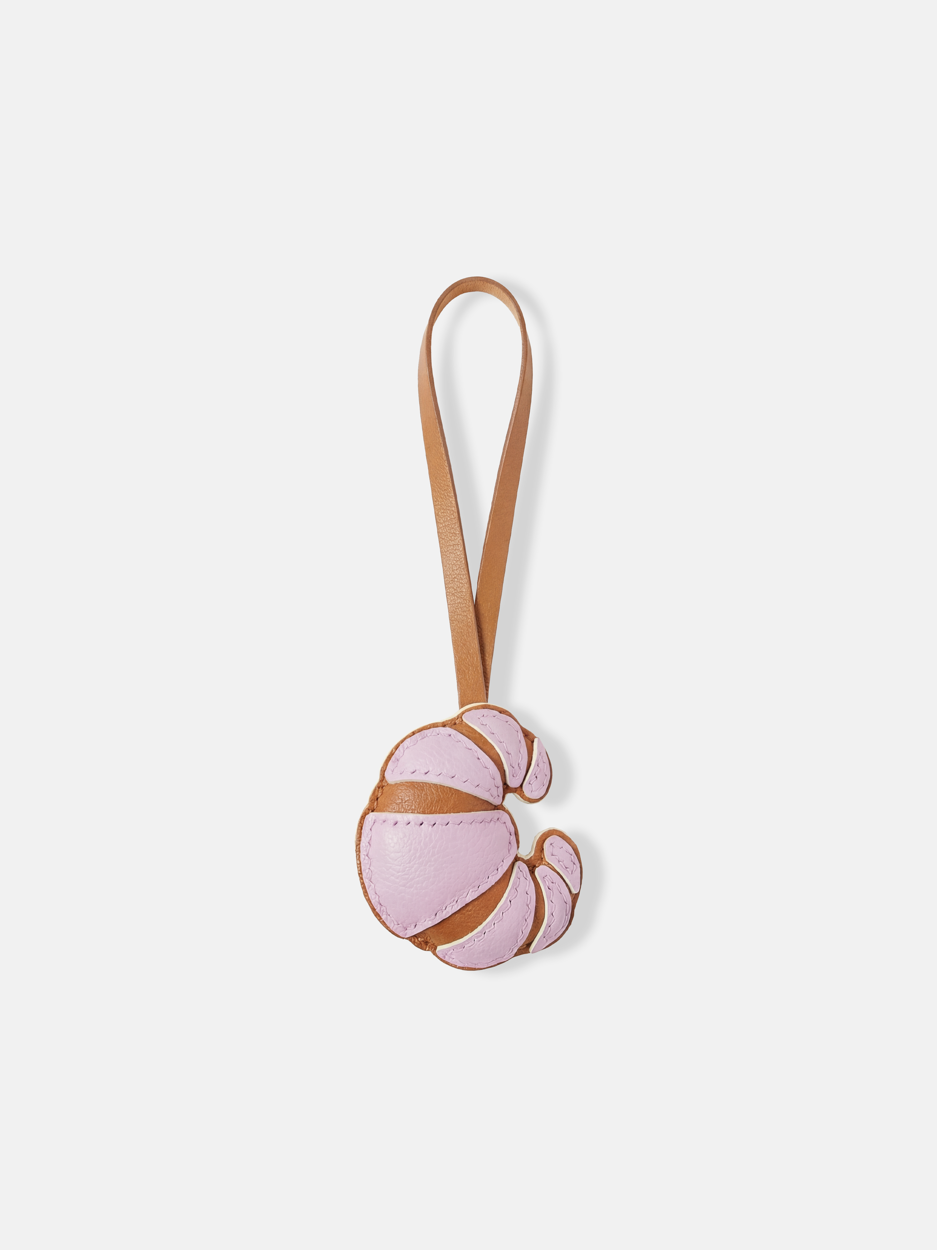 Selvane Croissant Bag Charm, a compact crescent of supple leather with rounded volume and clean seams, designed to sway.