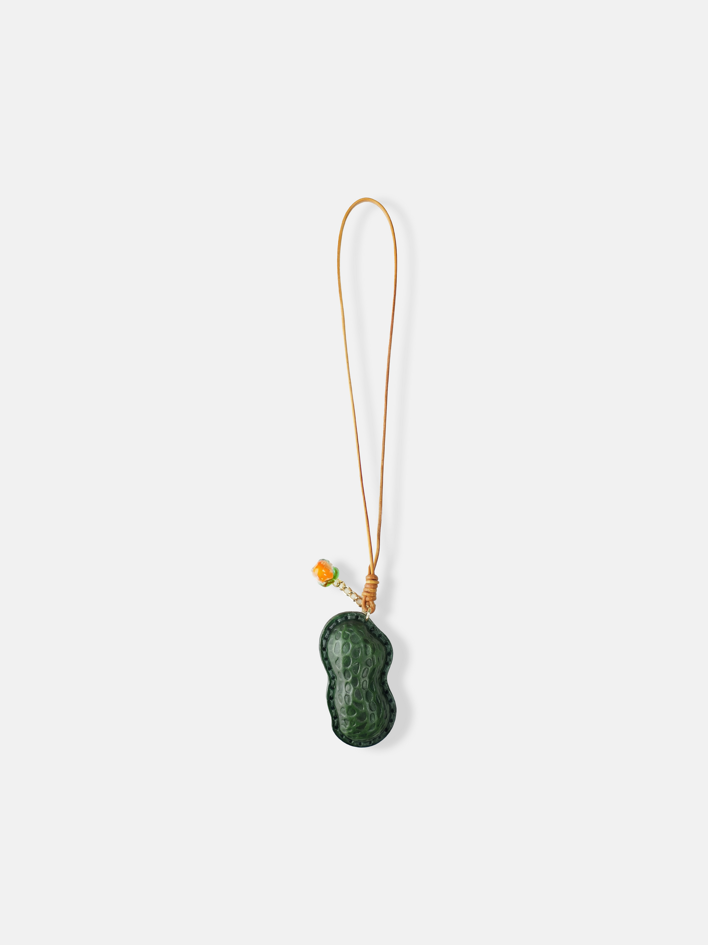 Selvane Peanut Pod Bag Charm, a sculpted leather peanut silhouette with contrast stitching, attached to a slim strap.