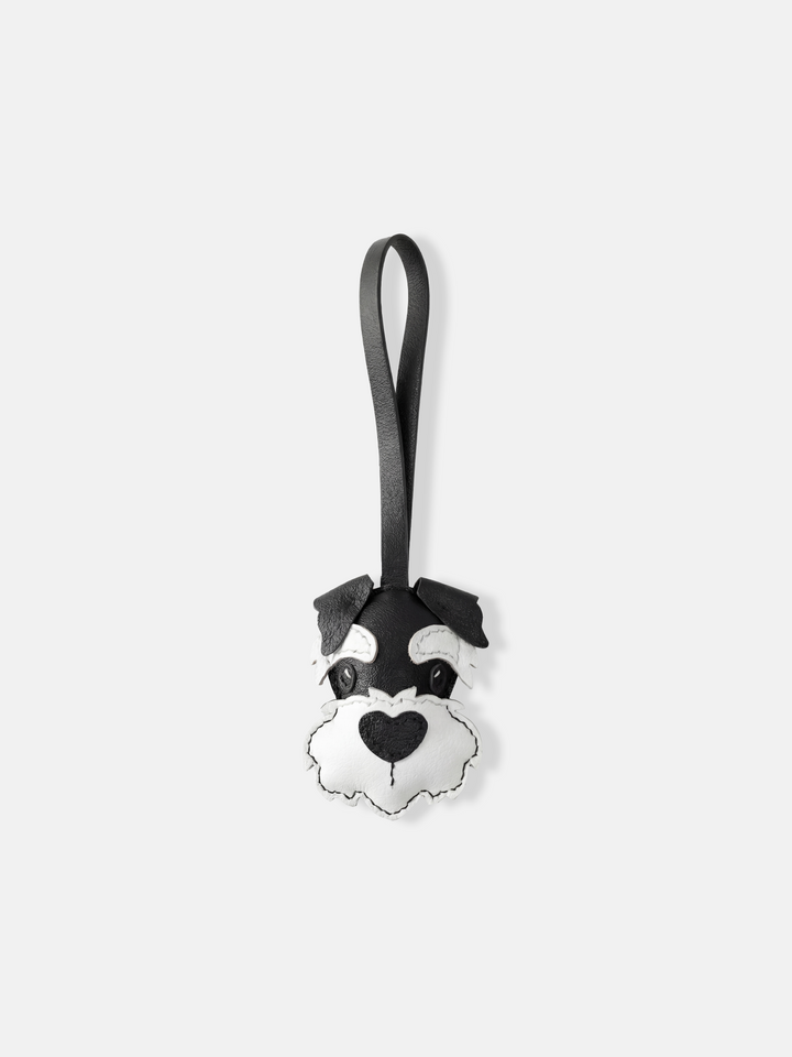 Selvane Schnauzer Face Bag Charm in layered leather, featuring sharp ears, arched brows, and a sculpted beard, with a slim strap for vertical elegance.