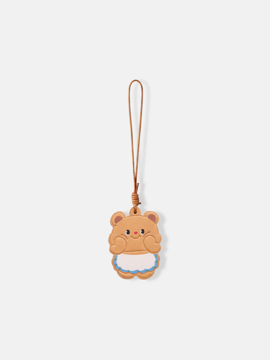 A compact, character-led Selvane Little Bear Bag Charm with rounded edges and a long leather lanyard, designed to sit sweetly on a bag.