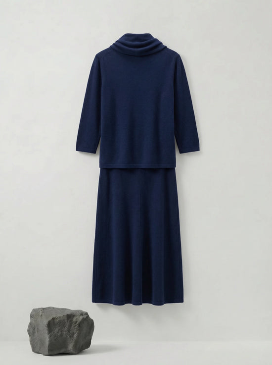 Model wearing a deep navy Tencel-blend cowl-neck top and matching midi pencil skirt set, styled elegantly.