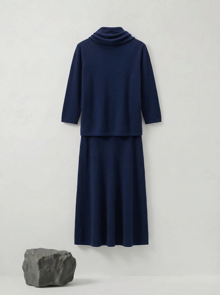 Model wearing a deep navy Tencel-blend cowl-neck top and matching midi pencil skirt set, styled elegantly.