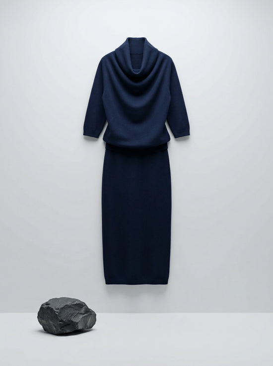 Model wearing a deep navy Tencel-blend cowl-neck top and matching midi pencil skirt set, styled elegantly.