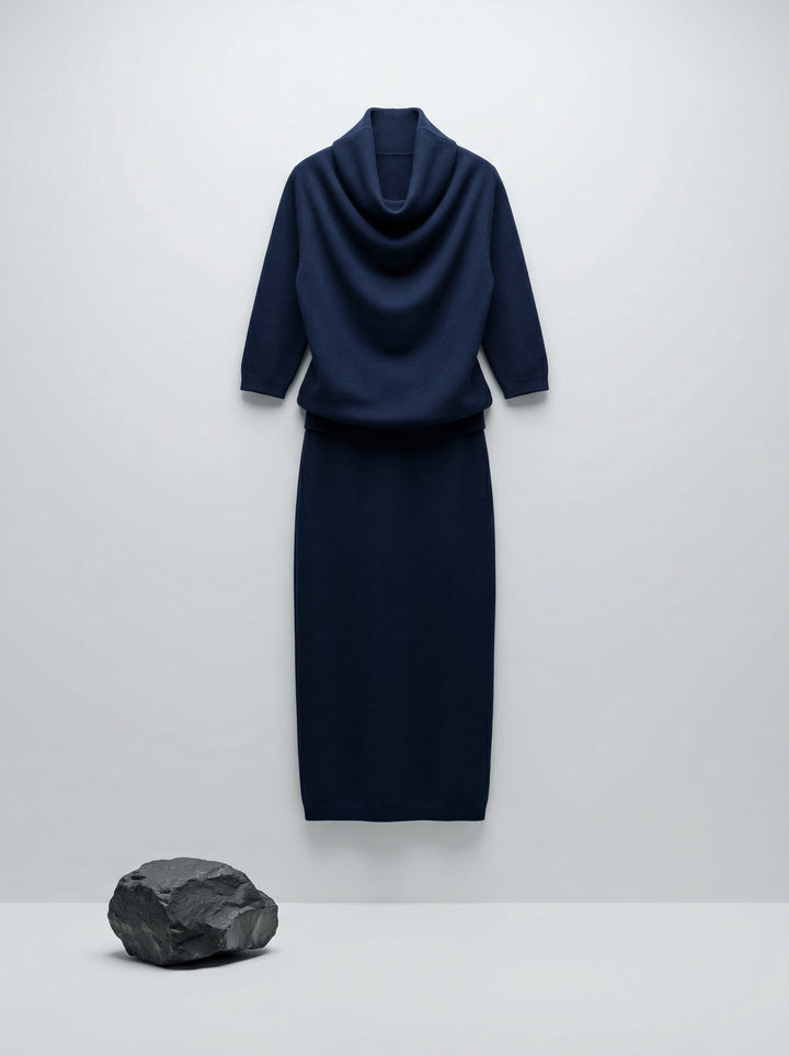 Model wearing a deep navy Tencel-blend cowl-neck top and matching midi pencil skirt set, styled elegantly.