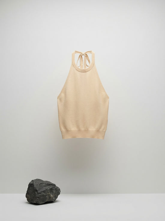 SELVANE warm ivory cowl-neck halter top, featuring architectural drape, semi-sheer fine-gauge knit, and relaxed body-skimming silhouette.