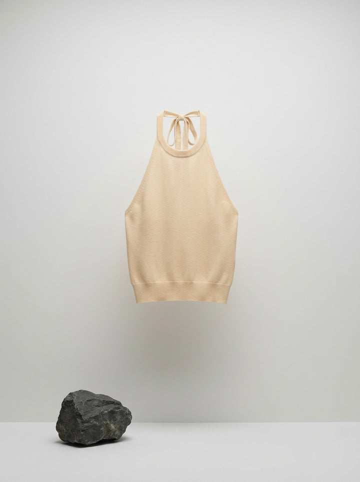 SELVANE warm ivory cowl-neck halter top, featuring architectural drape, semi-sheer fine-gauge knit, and relaxed body-skimming silhouette.