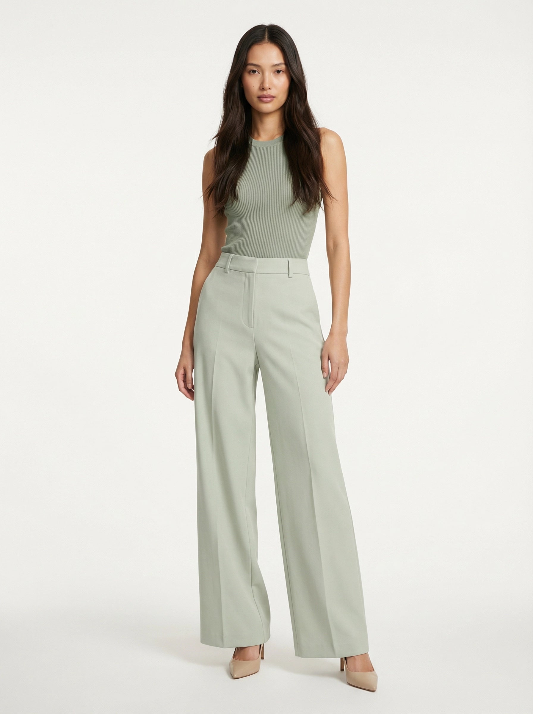 Model wearing SELVANE sage green ribbed knit tank and high-waisted wide-leg trousers set, standing elegantly.