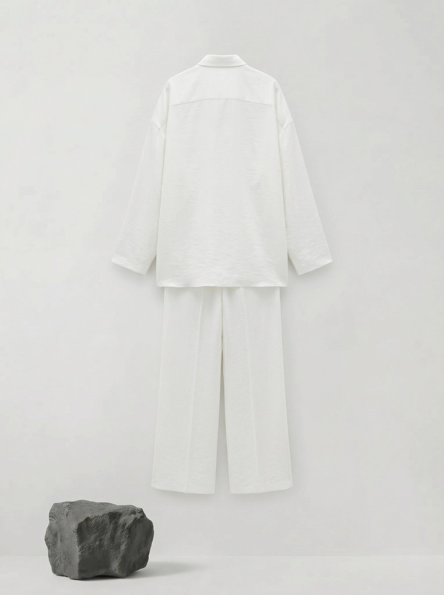 SELVANE pure white bow-tie blouse and wide-leg trousers set in luminous, crinkled acetate fabric, styled elegantly.