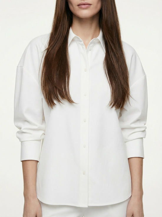 SELVANE pure white bow-tie blouse and wide-leg trousers set in luminous, crinkled acetate fabric, styled elegantly.