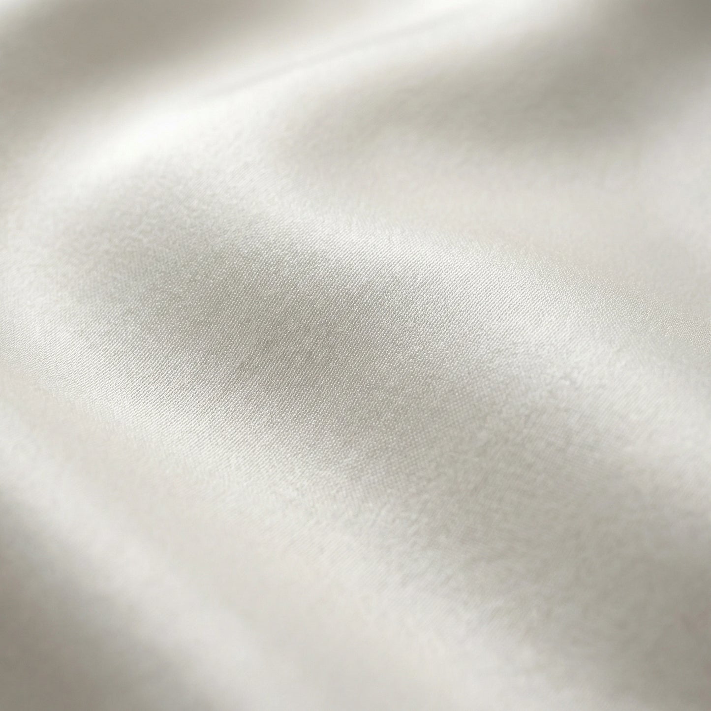 SELVANE pure white bow-tie blouse and wide-leg trousers set in luminous, crinkled acetate fabric, styled elegantly.